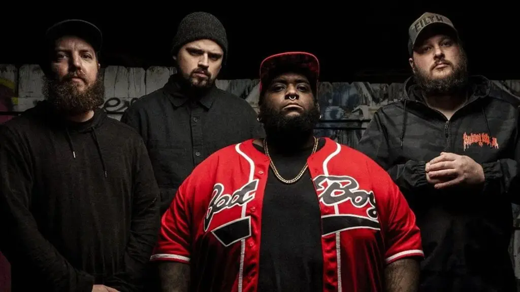 Filth band promo — four members posed against graffiti wall, vocalist in red baseball jersey
