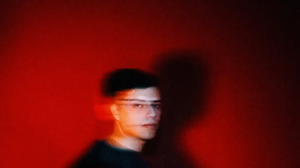 RZRKT bass music producer official portrait with red ambient lighting