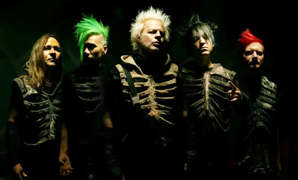 Powerman 5000 official press photo — five members in skeleton costumes against dark green lighting