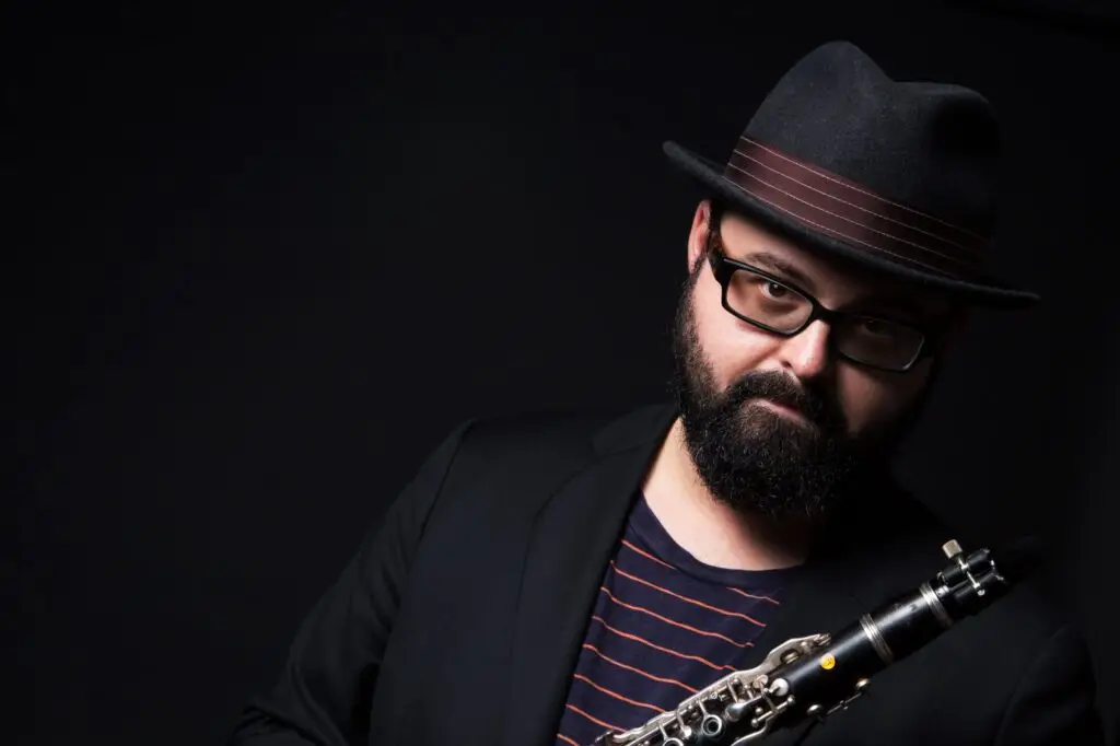 Michael Winograd, klezmer clarinetist, holding clarinet in press photo